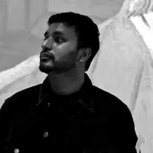 Nishanth Veduruvada, in front of a projection of Van Gogh's self-portrait